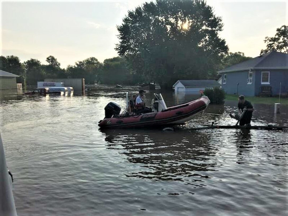 Firefighters prepare to launch a boat for a rescue operation.