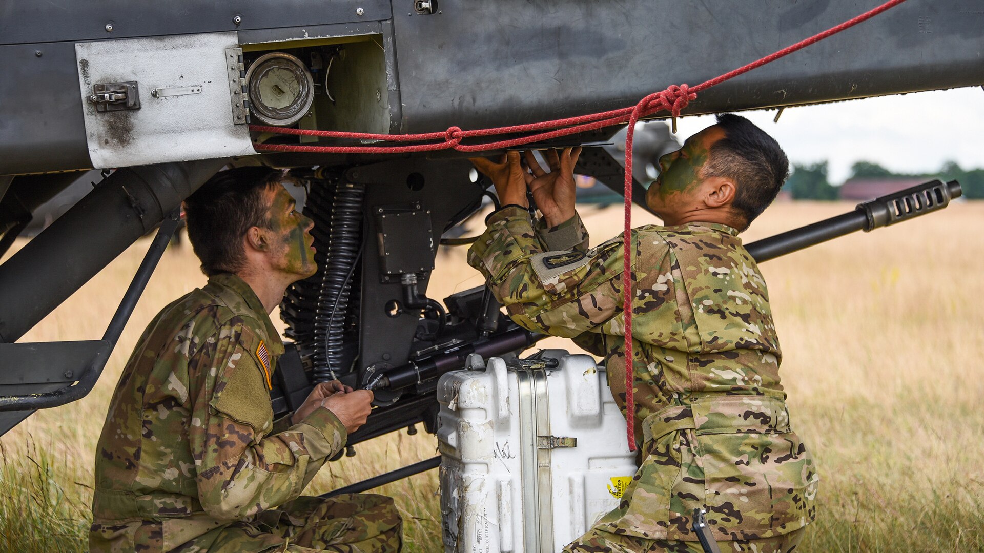 Army Sgt. Nathan Choi and Pfc. Matthew Hanneman from the 12th Combat Aviation Brigade conduct maintenance on AH-64 Apache helicopter during Saber Strike 2018 at Bemowo Piskie Training Area in Orzysz, Poland. DLA equipped exercise participants with everything from repair parts to fuel.