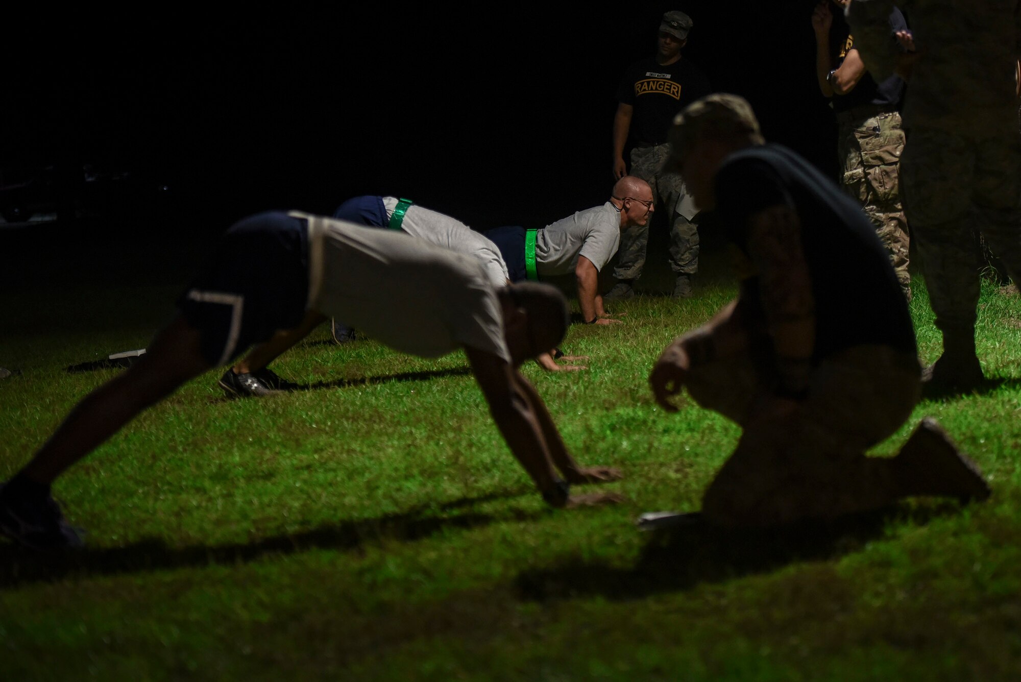 Pre-Ranger Assessment Course (Pre-RAC) instructors evaluate Airmen performing push ups during a Pre-RAC, Aug. 24, 2018, at Moody Air Force Base, Ga. Moody’s 93d Air Ground Operations Wing hosted the three-day assessment which challenged approximately 20 Airmen from the 93d AGOW and 23d Wing on their physical fitness, land navigation skills, leadership qualities, water confidence and academic and tactical abilities under duress. The evaluation is designed to determine whether Airmen are ready to attend the Air Force Ranger Assessment Course held at Fort Bliss, Texas. (U.S. Air Force photo by Senior Airman Greg Nash)