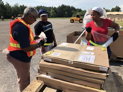 Members of DLA Distribution Depot Powidz, Poland, wrap a pallet of supplies destined for customers at a remote training site for Saber Strike 2018.