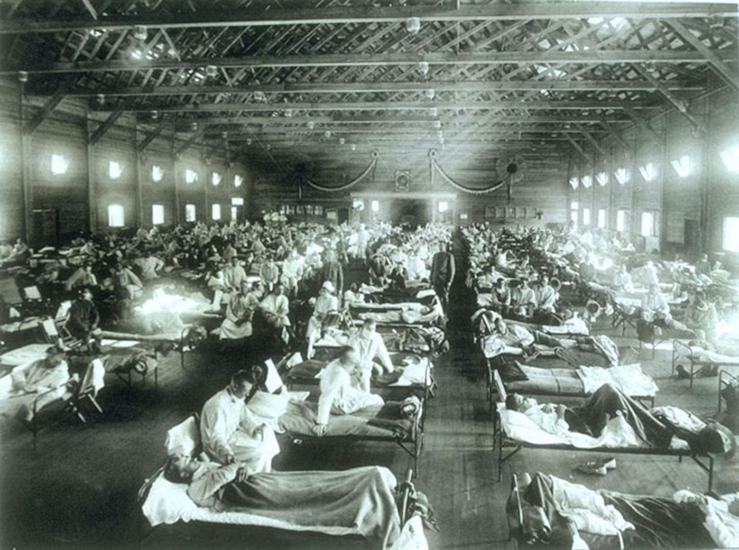 Soldiers suffering from influenza at the hospital in Camp Funston, Kansas, in 1918. Camp Funston was where the influenza epidemic which would kill more than 50 million people world-wide, including 675,000 Americans, first made a major appearance. Troops from the camp carried the virus to other Army bases during World War I.