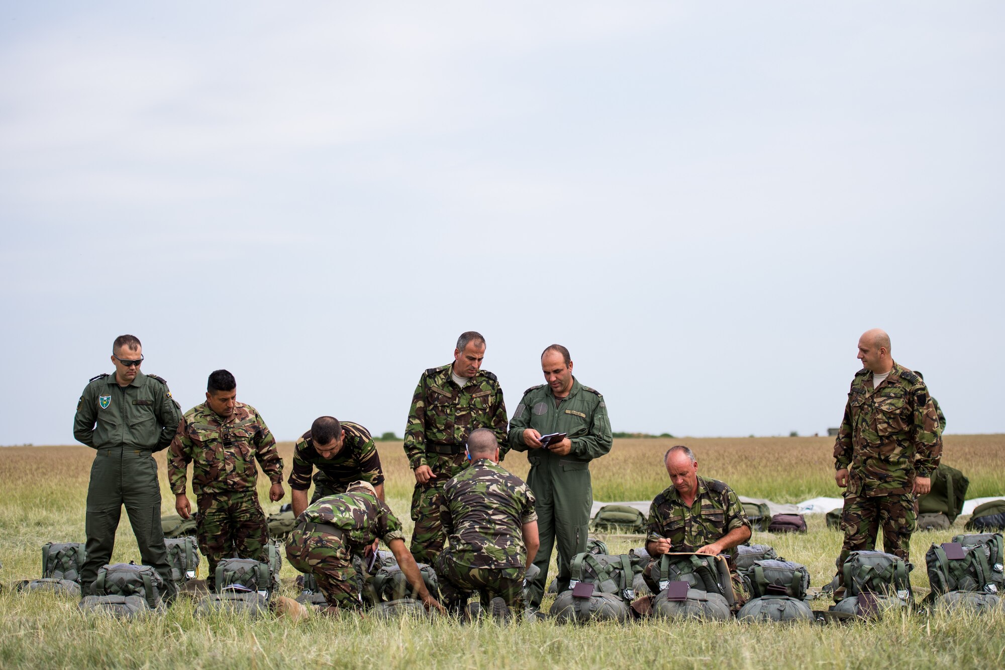 Romanian air force paratroopers prepare to board U.S. Air Force C-130J Super Hercules aircraft assigned to the 37th Airlift Squadron, Ramstein Air Base, Germany, as part of exercise Carpathian Summer 2018 at Boboc Air Base, Romania, Aug. 23, 2018. Carpathian Summer is a bilateral training exercise designed to enhance interoperability and readiness of forces by conducting combined air operations with the Romanian air force. (U.S. Air Force photo by Senior Airman Devin Boyer)