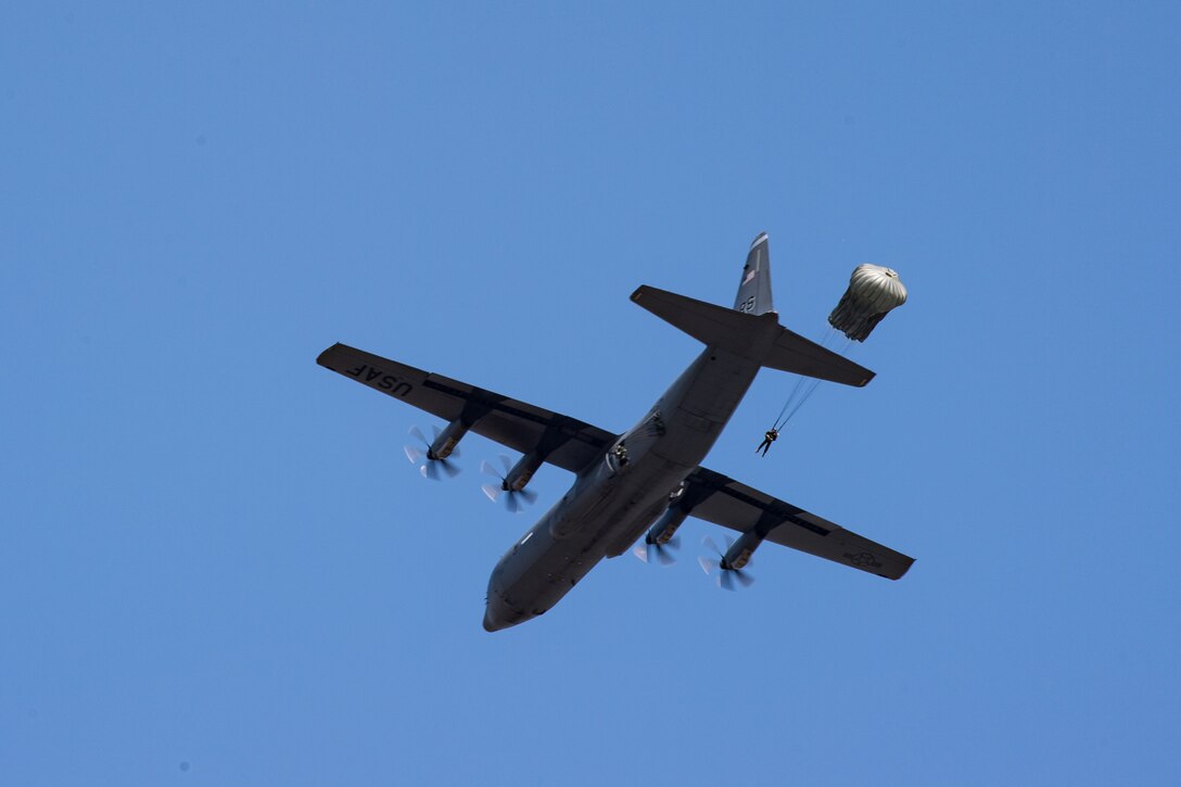 Romanian air force paratroopers jump out of a U.S. Air Force C-130J Super Hercules aircraft assigned to the 37th Airlift Squadron, Ramstein Air Base, Germany, over Boboc Air Base, Romania, Aug. 23, 2018. The airdrops were part of exercise Carpathian Summer 2018, a bilateral training exercise designed to enhance interoperability and readiness of forces by conducting combined air operations with the Romanian air force. (U.S. Air Force photo by Senior Airman Devin Boyer)