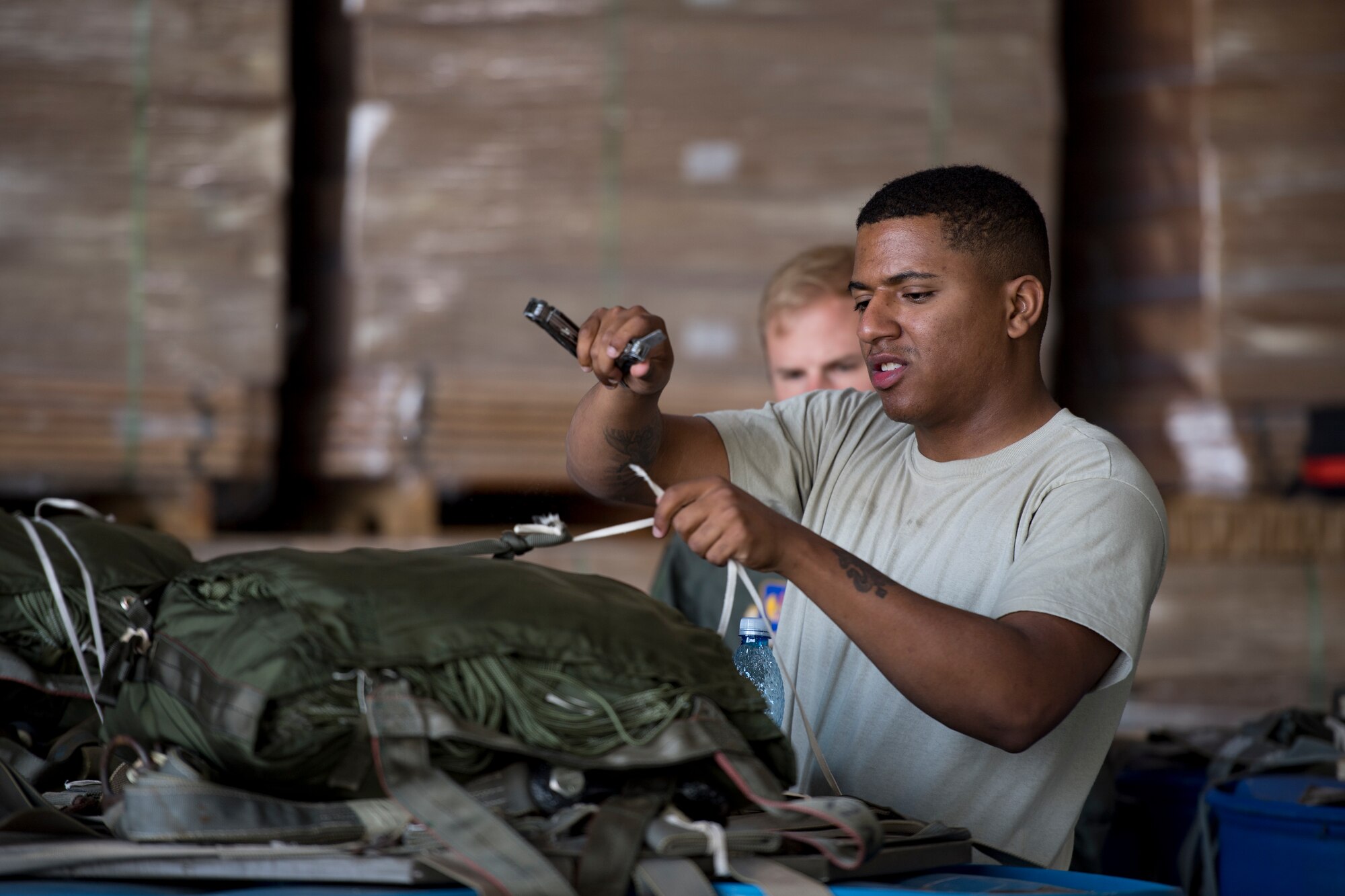 U.S. Air Force Senior Airman Marc Bundy, 86th Logistics Readiness Squadron aerial delivery specialist, prepares a container delivery system for airdrops at Otopeni Air Base, Romania, Aug. 22, 2018. The CDS bundles were dropped from C-130J Super Hercules aircraft assigned to the 37th Airlift Squadron, Ramstein Air Base, Germany, as part of Carpathian Summer 2018. (U.S. Air Force photo by Senior Airman Devin Boyer)
