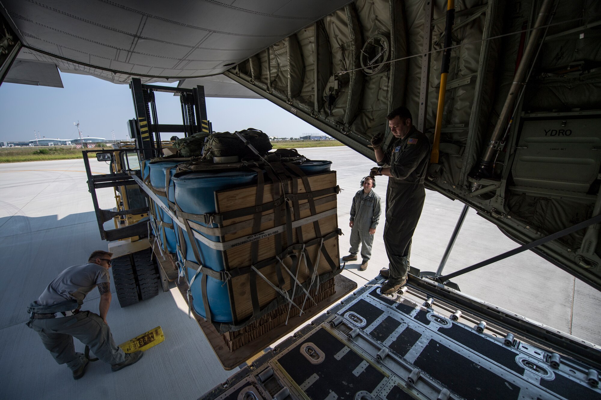 Romanian air force and U.S. Air Force personnel load container delivery system bundles onto a C-130J Super Hercules aircraft assigned to the 37th Airlift Squadron, Ramstein Air Base, Germany, as part of exercise Carpathian Summer 2018 at Otopeni Air Base, Romania, Aug. 22, 2018. Carpathian Summer is a bilateral training exercise designed to enhance interoperability and readiness of forces by conducting combined air operations with the Romanian air force. (U.S. Air Force photo by Senior Airman Devin Boyer)