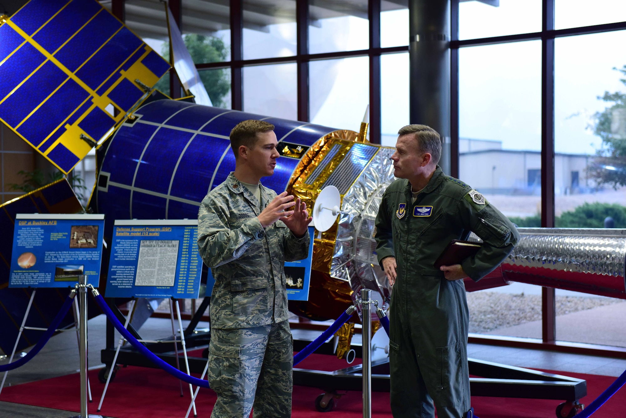 Maj. Micah Dodds, left, 11th Space Warning Squadron director of operations, describes the role Team Buckley plays in defense of the nation to Gen. Tod D. Wolters, U.S. Air Forces in Europe and Air Forces Africa commander, in the Space Based Infrared System Mission Control Station lobby at Buckley Air Force Base, Colorado, Aug. 8, 2018.