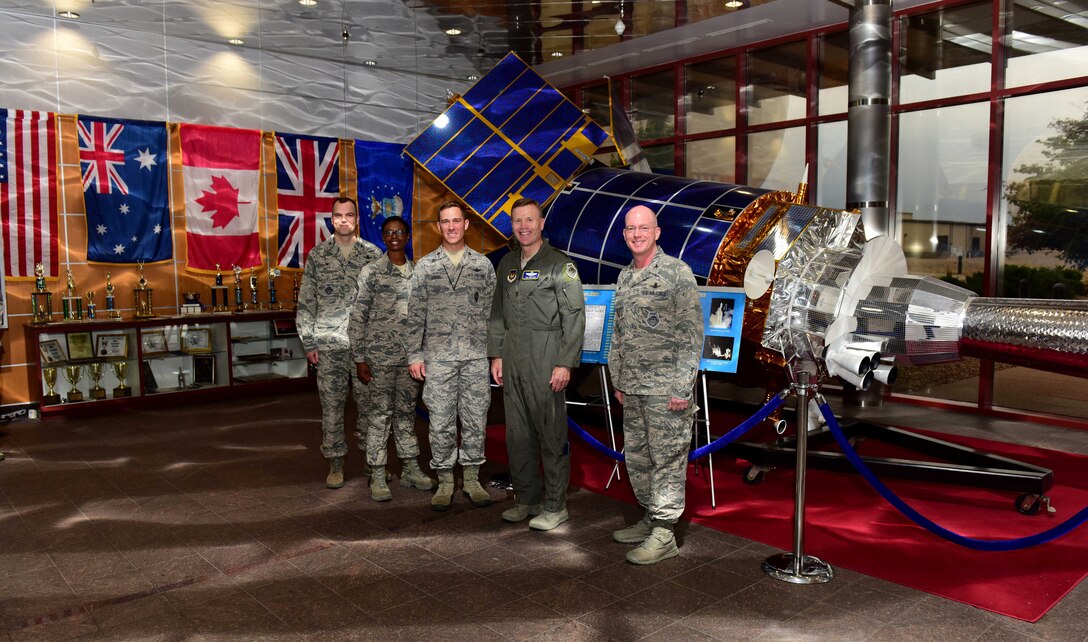 From left to right, Col. Robert Hutt, 460th Operations Group commander, Chief Master Sgt. Tamar Dennis, 460th Space Wing command chief, Maj. Micah Dodds, 11th Space Warning Squadron director of operations, Gen. Tod D. Wolters, U.S. Air Forces in Europe and Air Forces Africa commander, and Col. Troy L. Endicott, 460th SW commander, stand for a group photo in the Space Based Infrared System Mission Control Station lobby at Buckley Air Force Base, Colorado, Aug. 8, 2018.