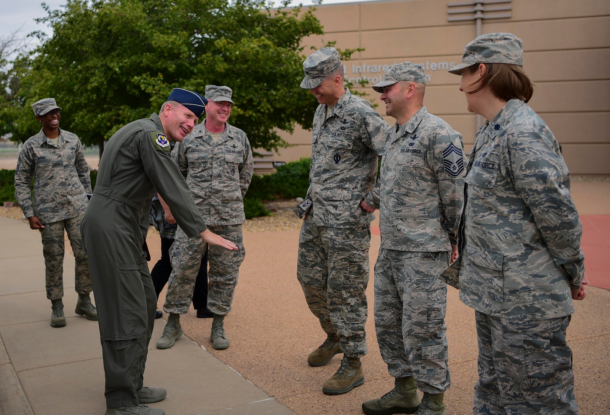 Gen. Tod D. Wolters, U.S. Air Forces in Europe and Air Forces Africa commander, jokes with Col. Robert Hutt, 460th Operations Group commander, during his visit Aug. 8, 2018, on Buckley Air Force Base, Colorado.