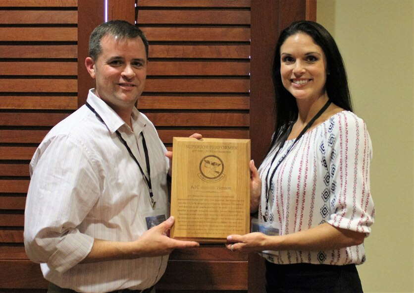 655th Intelligence, Surveillance and Reconnaissance Group 14th Intelligence Squadron Commander Lt. Col. Ben Smallwood presents Senior Airman Henson with a "Superior Performer" award at a leadership conference in San Antonio, Texas, July 25, 2018.