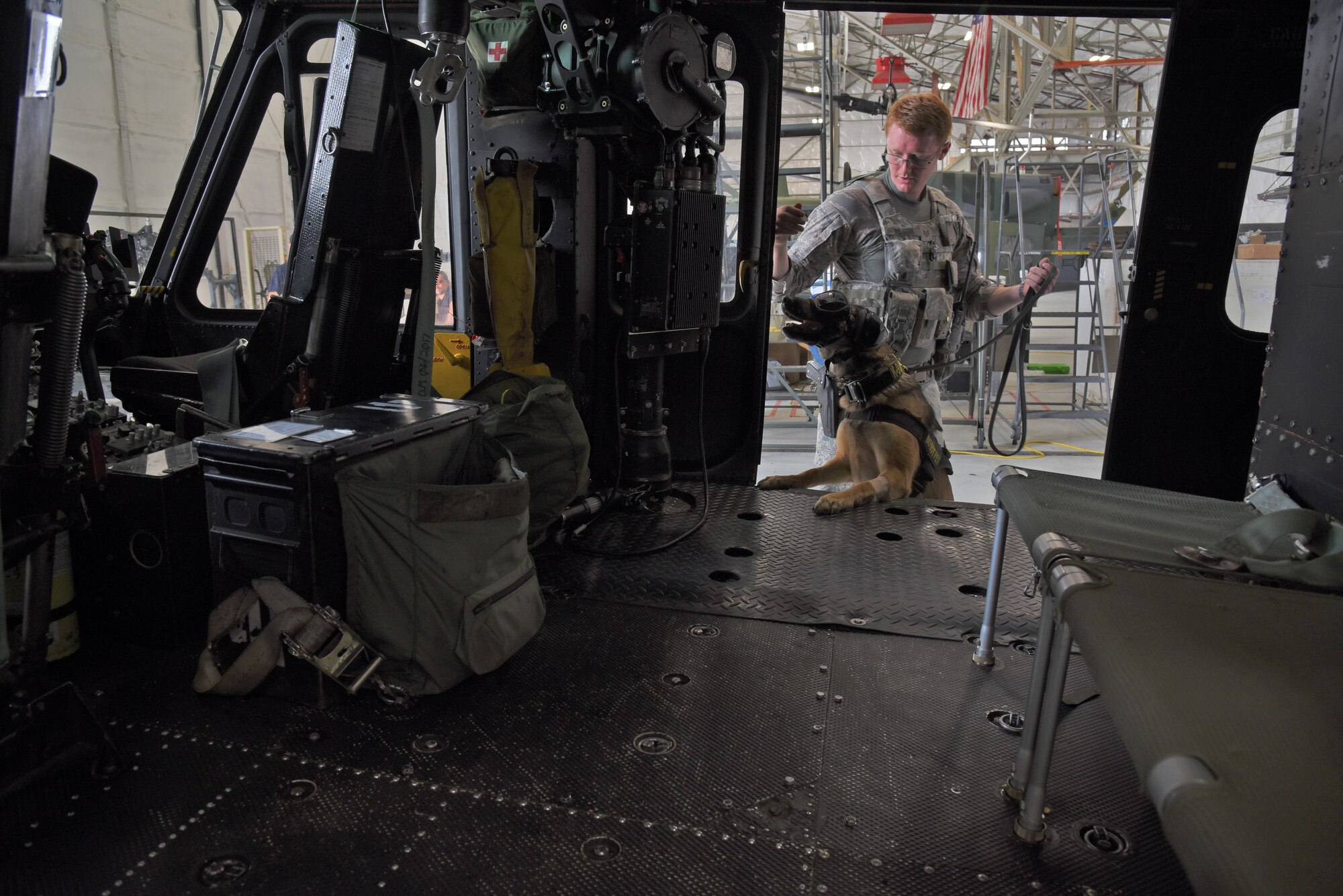 Staff Sgt. Jimmy Wilson, 92nd Security Forces Squadron Military Working Dog handler, runs through a detection exercise with MWD Fanni July, 31, 2018, at Fairchild Air Force Base, Washington. MWD focuses on detection of explosives and narcotics and deterrence of individuals at home, in training and while deployed. (U.S. Air Force photo/Staff Sgt. Mackenzie Mendez)