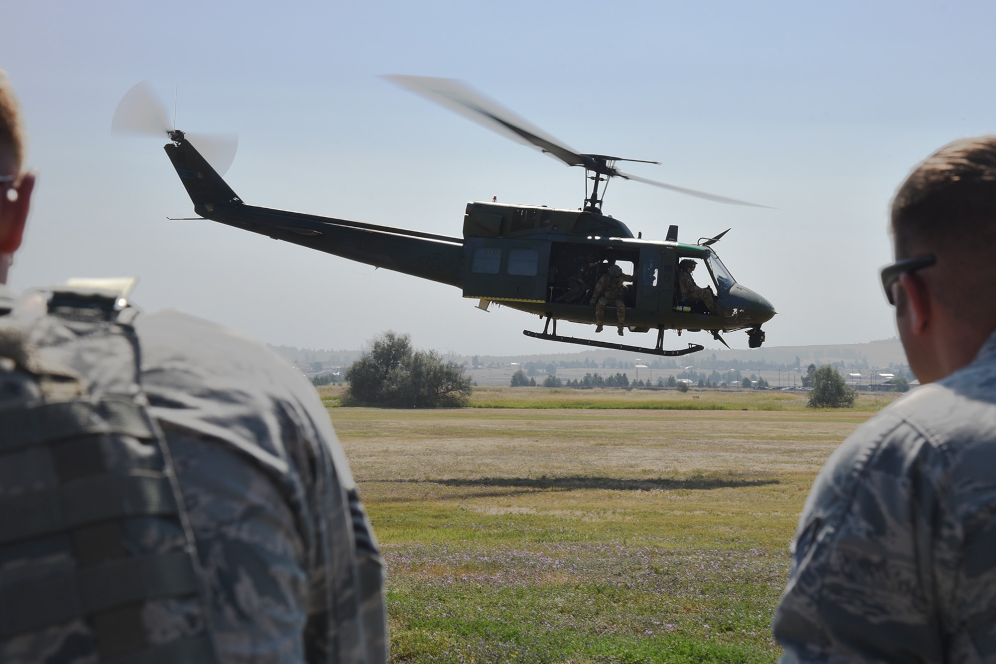 Throughout the month of August, the 92nd Security Forces Squadron Military Working Dog section trained with the 36th Rescue Squadron to learn and become familiar with the components of a UH-1N Huey aircraft. The 36th RQS spent numerous days teaching the handlers how to load and unload their dogs, how to safely fly with a canine and basic egress training in case of an emergency. (U.S. Air Force photo/Staff Sgt. Mackenzie Mendez)