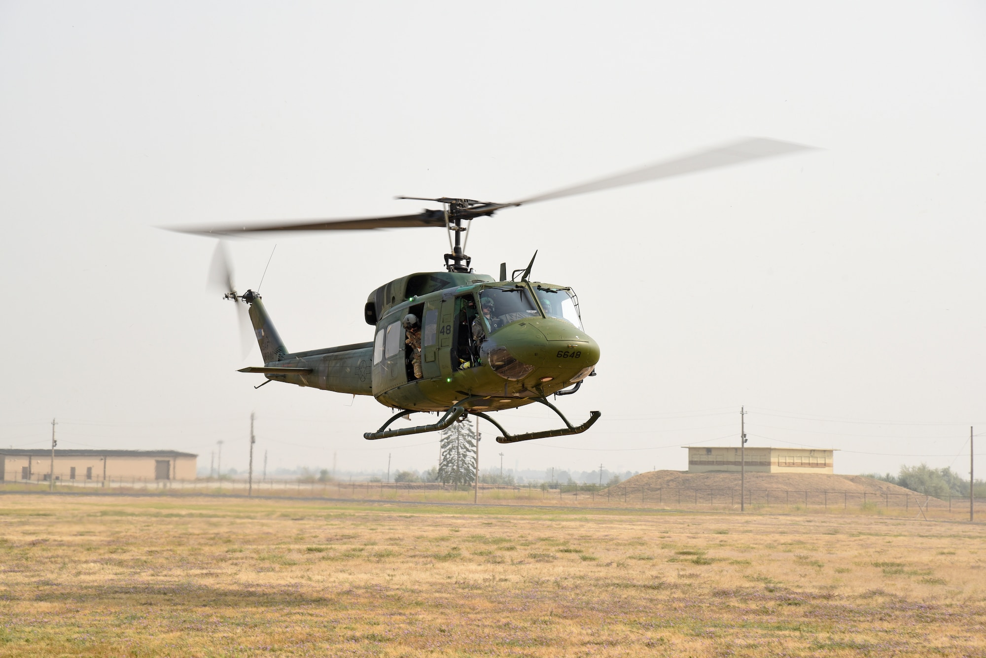 Throughout the month of August, the 92nd Security Forces Squadron Military Working Dog section trained with the 36th Rescue Squadron to learn and become familiar with the components of a huey aircraft. In addition to learning the nomenclature of a UH-1N Huey, the MWD teams were subjected to stimuli commonly found in a deployed location. (U.S. Air Force photo/Staff Sgt. Mackenzie Mendez)