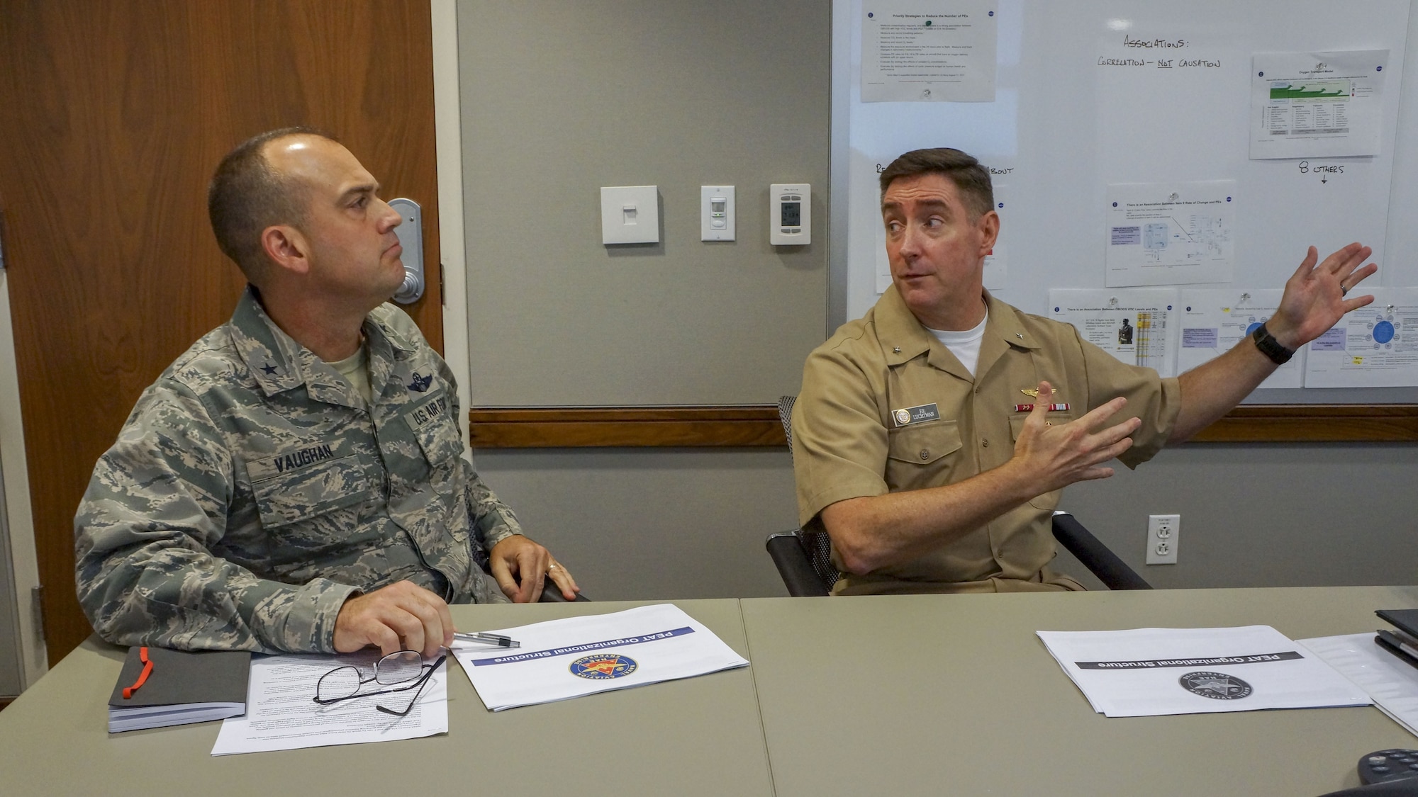 Air Force Brig. Gen. Edward L. Vaughan, head of the Air Force Unexplained Physiological Events Integration Team (UPE IT) and Rear Adm. Fredrick R. Luchtman, Navy Physiological Episodes Action Team (PEAT) lead, discuss ongoing efforts to minimize the risk of Physiological Episodes (PEs). The Navy and Air Force relationship enables the development of joint solutions to achieve a better understanding of the cockpit environment and oxygen systems to keep our aircrews safe. (U.S. Navy photo by Cmdr. Scot Cregan/Released