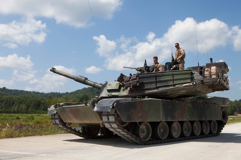 A crew of Marines from 1st Tank Battalion position the M1A1 Abrams tank for the 15th annual Tiger Competition ceremony at Wilcox range, Fort Knox, Kentucky, Aug. 28, 2018. The competition highlights the critical and quick-reacting combat skills of the participating battalions. (U.S. Marine Corps photo by Lance Cpl. Tessa D. Watts)