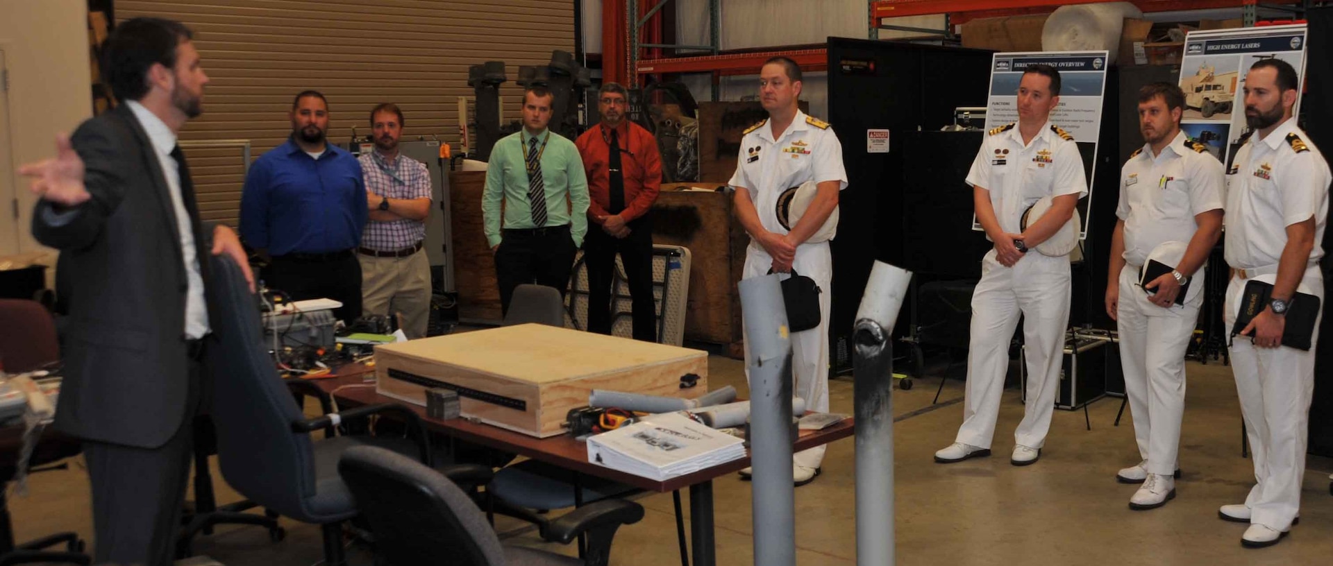 IMAGE: DAHLGREN, Va. (Aug. 16, 2018) – Dr. Chris Lloyd, High Energy Laser Lethality Lead at Naval Surface Warfare Center Dahlgren Division (NSWCDD), briefs Royal Australian Navy (RAN) Commodore Peter Leavy and his delegation at the NSWCDD Laser Lethality Lab during the RAN delegation's NSWCDD visit. Lloyd explained the importance of rigorous modeling and laboratory testing against target materials to ensure high energy laser systems are built that meet the requirements of the warfighter once fielded. NSWCDD is drawing on its knowledge of electromagnetic launchers, hypervelocity projectiles, and directed energy weapons, in addition to its established core capabilities in complex warfare systems development and integration to incorporate electric weapons technology into existing and future fighting forces and platforms. (Photo by U.S. Navy/Released)