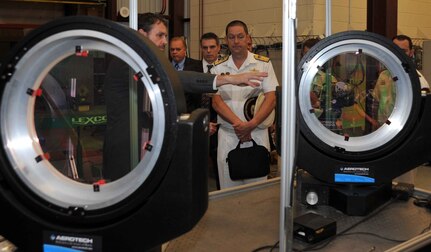 IMAGE: DAHLGREN, Va. (Aug. 16, 2018) – Dr. Chris Lloyd, High Energy Laser Lethality Lead at Naval Surface Warfare Center Dahlgren Division (NSWCDD), briefs Royal Australian Navy (RAN) Commodore Peter Leavy and his delegation at the NSWCDD Laser Lethality Lab during the RAN delegation's NSWCDD visit. Lloyd explained the importance of rigorous modeling and laboratory testing against target materials to ensure high energy laser systems are built that meet the requirements of the warfighter once fielded. NSWCDD is drawing on its knowledge of electromagnetic launchers, hypervelocity projectiles, and directed energy weapons, in addition to its established core capabilities in complex warfare systems development and integration to incorporate electric weapons technology into existing and future fighting forces and platforms. (Photo by U.S. Navy/Released)