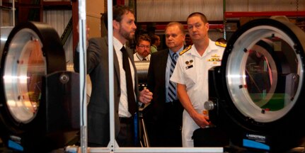 IMAGE: DAHLGREN, Va. (Aug. 16, 2018) – Dr. Chris Lloyd, High Energy Laser Lethality Lead at Naval Surface Warfare Center Dahlgren Division (NSWCDD), briefs Royal Australian Navy (RAN) Commodore Peter Leavy and his delegation at the NSWCDD Laser Lethality Lab during the RAN delegation's NSWCDD visit. Lloyd explained the importance of rigorous modeling and laboratory testing against target materials to ensure high energy laser systems are built that meet the requirements of the warfighter once fielded. NSWCDD is drawing on its knowledge of electromagnetic launchers, hypervelocity projectiles, and directed energy weapons, in addition to its established core capabilities in complex warfare systems development and integration to incorporate electric weapons technology into existing and future fighting forces and platforms. (Photo by U.S. Navy/Released)