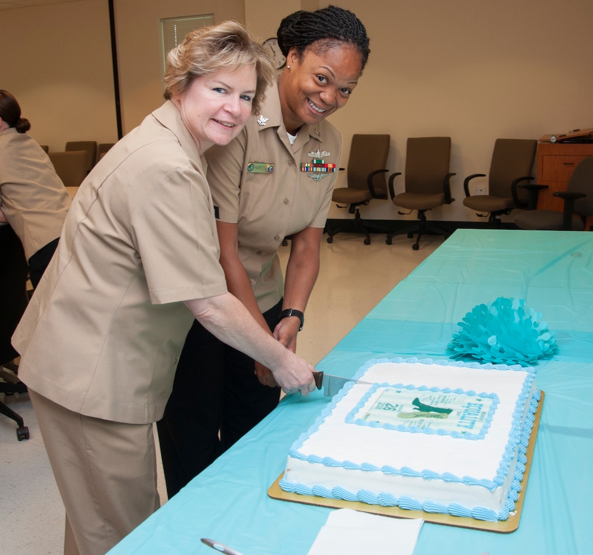 Capt. Maryann Mattonen (left), commanding officer, Navy Medicine Training Support Center, and Petty Officer 2nd Class Tereca Harris, an instructor with the Hospital Corpsman Basic program at the Medical Education and Training Campus at Joint Base San Antonio-Fort Sam Houston, cut a cake in celebration of Women’s Equality Day.