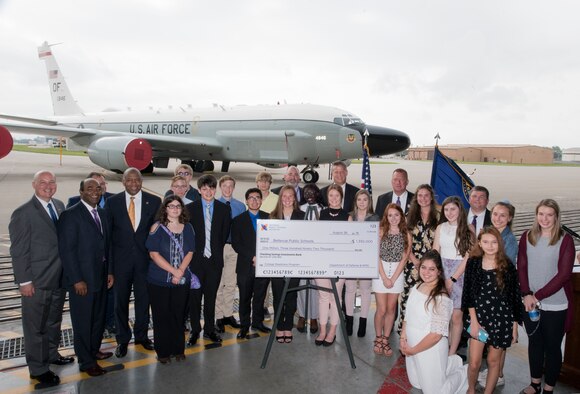 Representatives from U.S. Department of Defense, Nebraska and educational organizations pose for a photo August 28, 2018 inside an aircraft hangar at Offutt AFB, Nebraska with Advanced Placement students from Bellevue Public Schools following the presentation of a check by the DoD representing the award of $1.3 million to the Bellevue Public Schools STEM program. The award is part of the National Math and Science Initiative that promotes STEM education in more than 200 U.S. schools that have significant enrollment among military-connected students. (U.S. Air Force photo by Delanie Stafford)