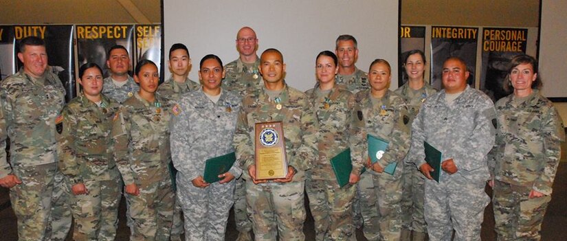304th Sust. Brig. Soldiers pose with their unit and individual awards