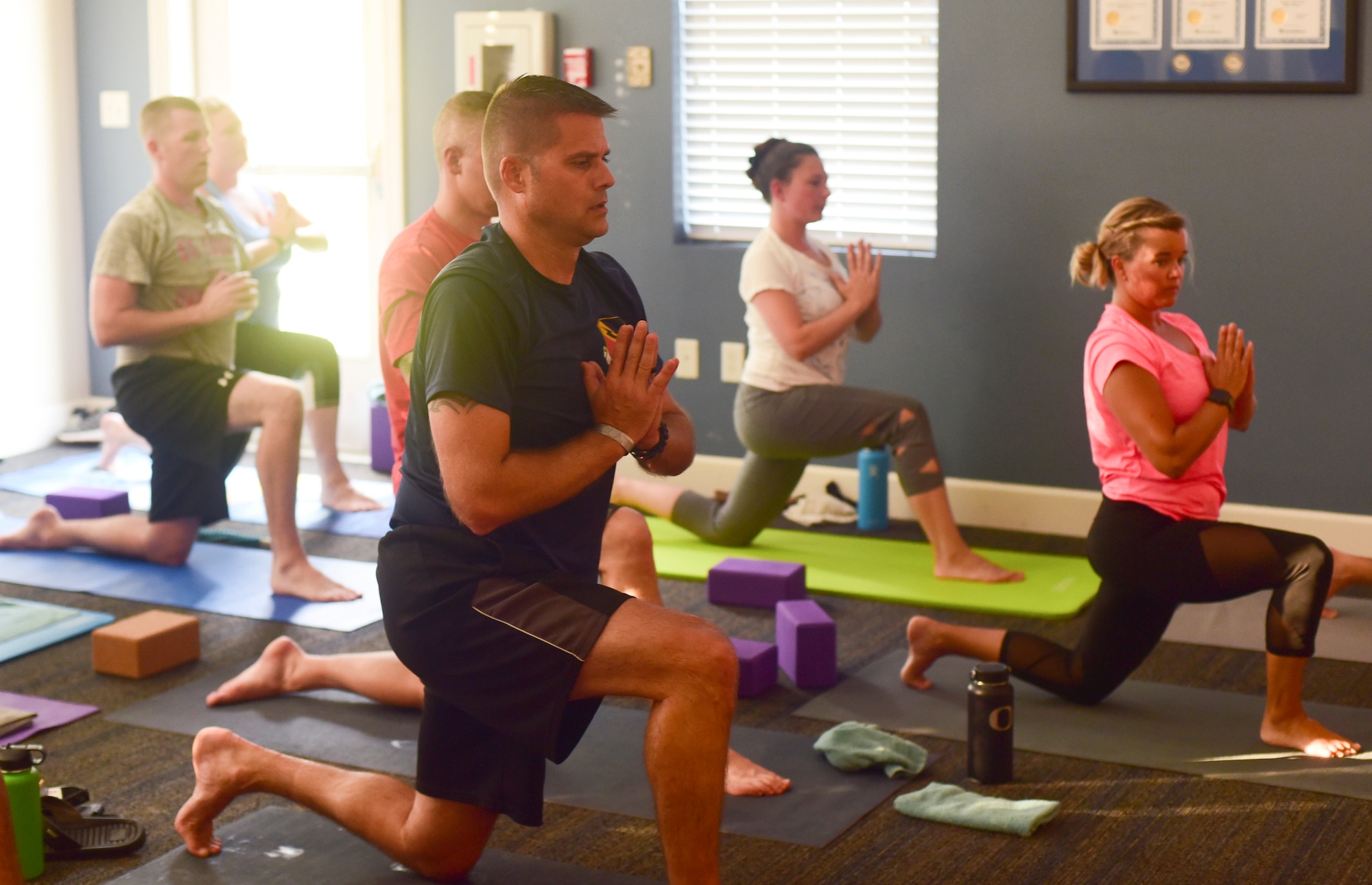 Members of the Tyndall community group, Tyndall Pacesetters, take part in various yoga stances and positions during a weekly yoga session at the Balfour Beatty Community Center on Tyndall Air Force Base, Florida, Aug. 22, 2018. Currently, the group averages 10-18 members per class and meets every Monday, Wednesday and Friday. The Pacesetters strive to improve the overall health and wellness of 325th Fighter Wing Airmen and their families. (U.S. Air Force photo by Senior Airman Cody R. Miller)