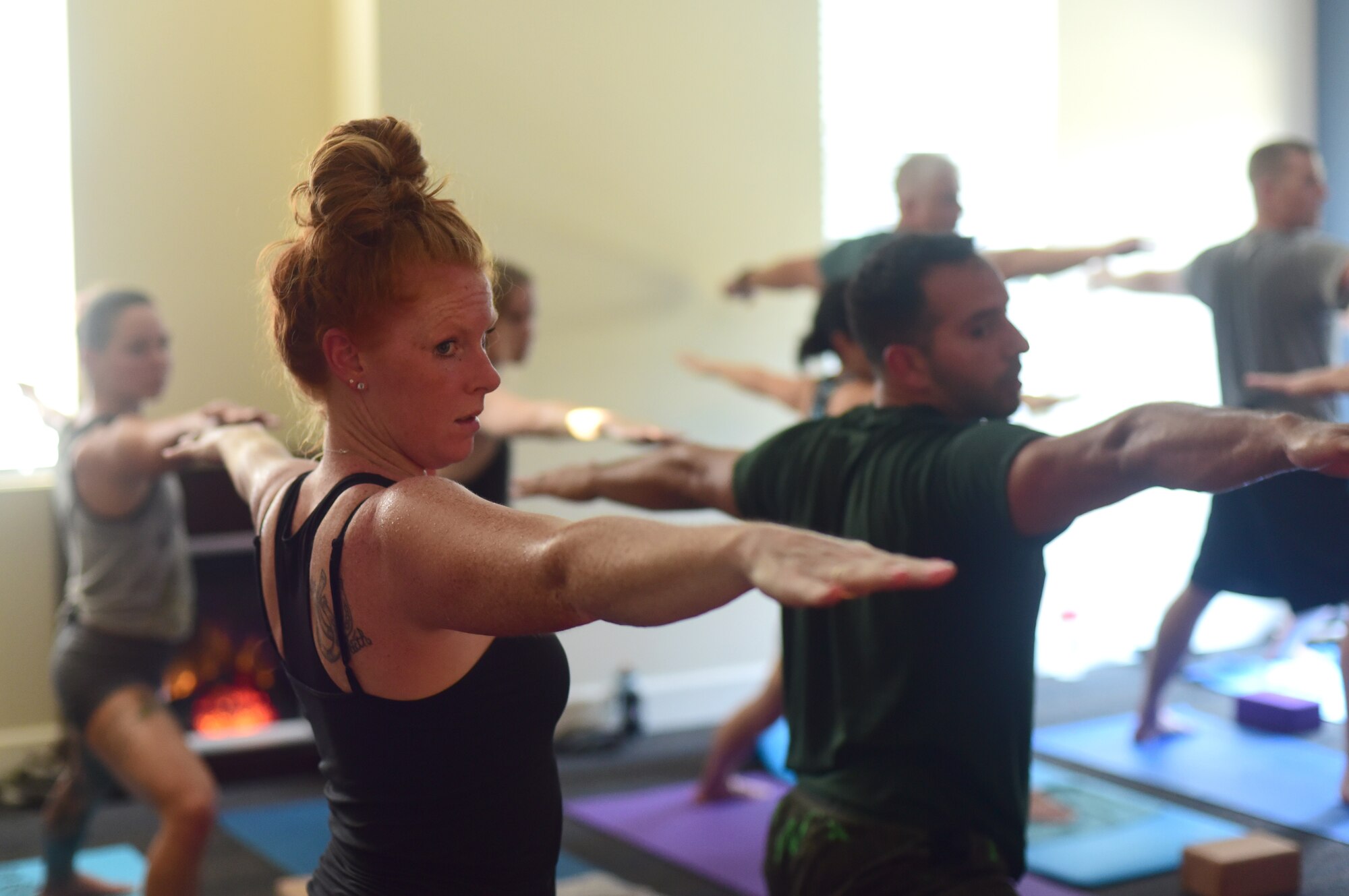 Members of the Tyndall community group, Tyndall Pacesetters, perform concentrated and controlled stretches during one of their weekly yoga sessions at the Balfour Beatty Community Center on Tyndall Air Force Base, Florida, Aug. 22, 2018. Currently, the group averages 10-18 members per class and meets every Monday, Wednesday and Friday. The Pacesetters strive to improve the overall health and wellness of 325th Fighter Wing Airmen and their families. (U.S. Air Force photo by Senior Airman Cody R. Miller)