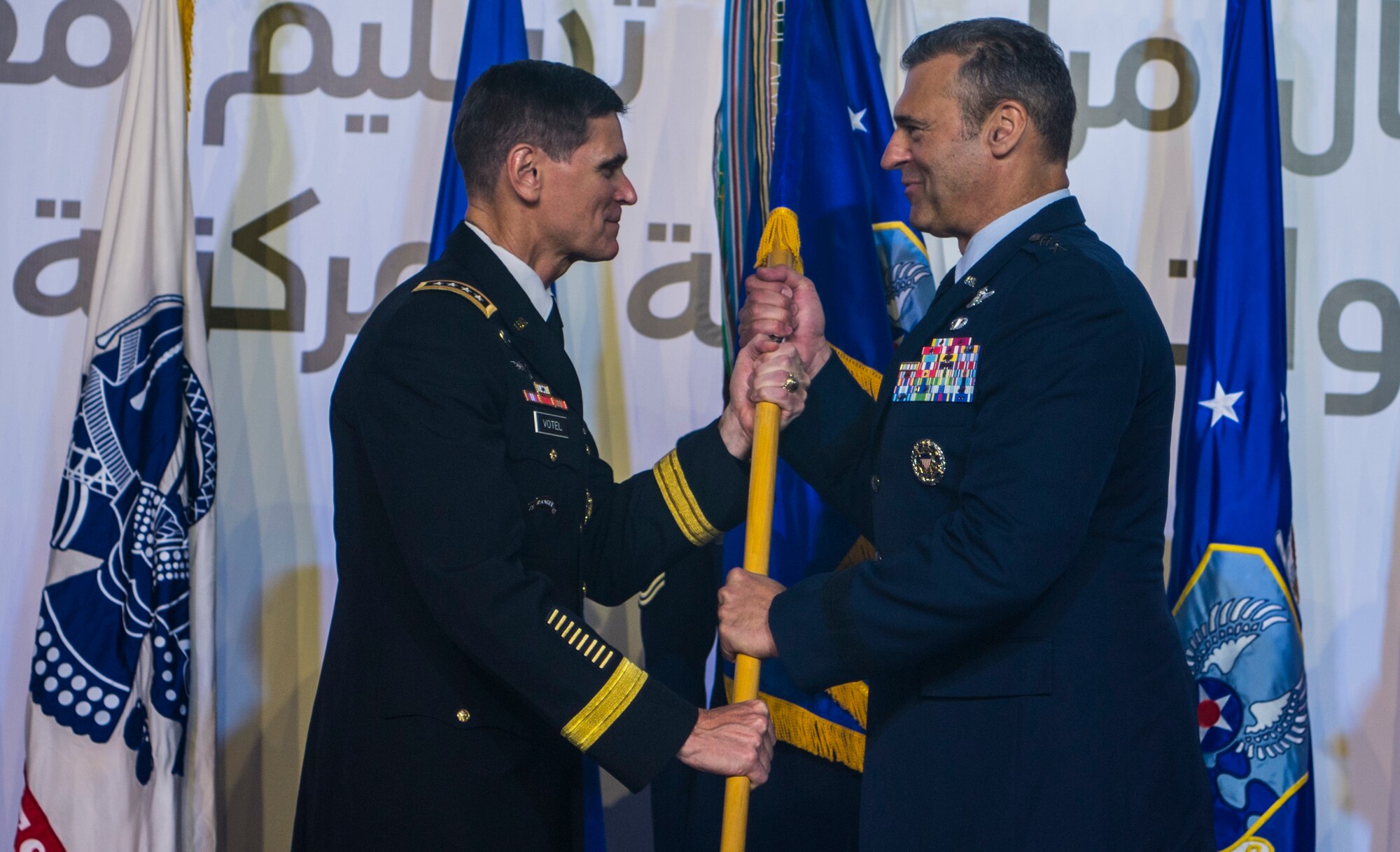 U.S. Army Gen. Joseph L. Votel, Commander of U.S. Central Command (CENTCOM), passes the guidon to U.S. Air Force Lt. Gen. Joseph T. Guastella Jr., Commander of U.S. Air Forces Central Command (AFCENT), during a change of command ceremony at Al Udeid Air Base, Qatar, Aug. 30, 2018. As the Combined Force Air Component Commander for CENTCOM, Guastella is responsible for developing contingency plans and conducting air operations in a 20-nation area of responsibility covering Central and Southwest Asia. AFCENT, in concert with coalition, joint, and interagency partners, delivers decisive air, space and cyberspace capabilities for CENTCOM, allied nations, and America. (U.S. Air Force photo by Senior Airman Xavier Navarro)