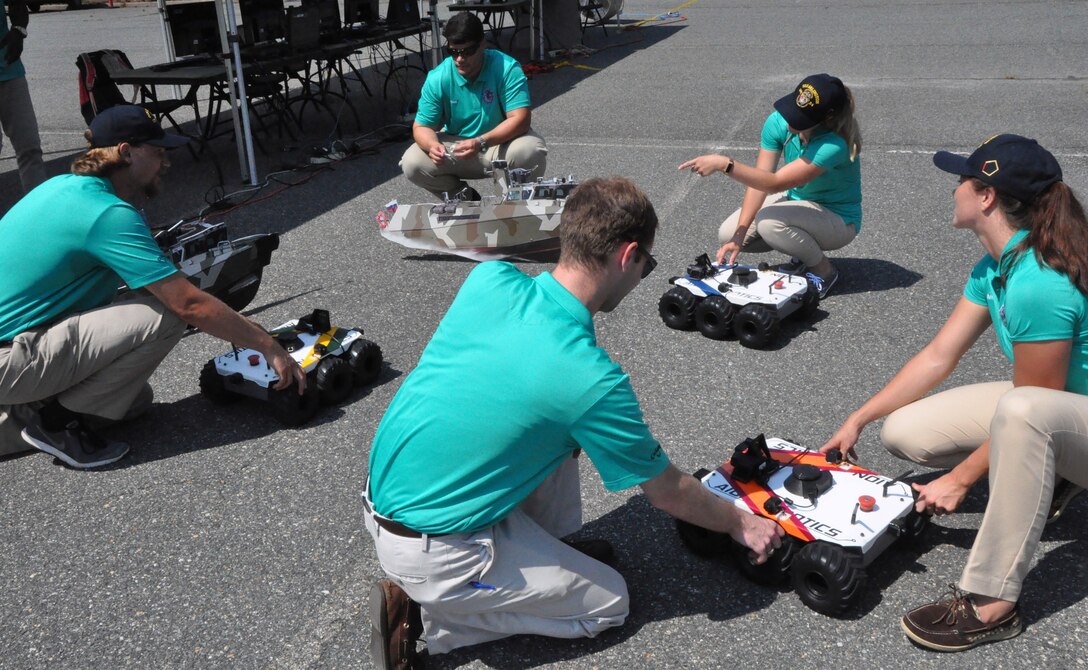 IMAGE: DAHLGREN (Aug. 7, 2018) – The Naval Surface Warfare Center Dahlgren Division (NSWCDD) Sly Fox Mission 23 team in action while demonstrating ARTEMIS - Autonomous Remote Tactical Engagement Multi-Domain Intelligence Swarm – capabilities. Over the past six months, the team used artificial intelligence and machine learning to develop unmanned vehicle swarms that can counteract potential threats of swarming unmanned systems. The Sly Fox program is an NSWCDD Naval Innovative Science and Engineering (NISE) funded rapid prototyping program intended to develop the science and engineering workforce – mostly junior scientists and engineers – while applying their talents to known technology gaps. NISE is part of National Defense Authorization Act Section 219 legislation, allowing warfare centers and research labs to apply money invested in their organizations to research, engineering and technology. NISE efforts have provided breakthrough research and have been responsible for maturation and transition of technology to the warfighter and programs of record.