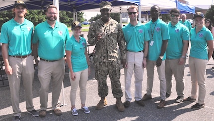 IMAGE: DAHLGREN (Aug. 7, 2018) – Naval Surface Warfare Center Dahlgren Division (NSWCDD) Commanding Officer Capt. Godfrey ‘Gus’ Weekes holds the USS Arlington (LPD-24) coin that was presented to NSWCDD Sly Fox Mission 23 team members while they were deployed aboard the Arlington for a week via the Scientists, Engineers and Logisticians to Sea program sponsored by NSWCDD Dam Neck Activity and NSWCDD. While at sea, the seven-member Mission 23 team presented the NSWCDD coin to Arlington’s commanding officer, who in turn, presented his warship’s coin to the Dahlgren junior scientists and engineers. Pictured left to right at the demonstration of Autonomous Remote Tactical Engagement Multi-Domain Intelligence Swarm capabilities: Conrad Brown, Ryan Munz, Kim Wendt, Capt. Weekes, Philip Costello, Devon McKiver, Luis Valcourt-Colon, and Melissa Markle.