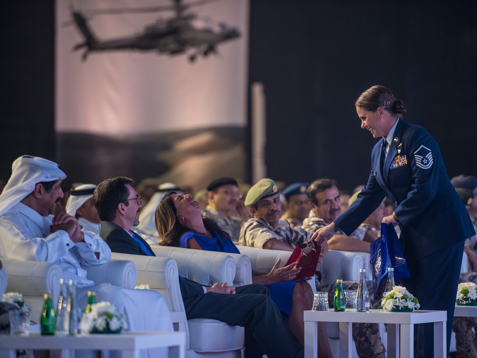 Mrs. Kathy Harrigian, spouse of Lt. Gen. Jeffrey L. Harrigian, outgoing U.S. Air Forces Central Command (AFCENT) commander, is presented a gift by a proffer during the AFCENT change of command ceremony at Al Udeid Air Base, Qatar, Aug. 30, 2018. Lt. Gen. Harrigian served as the AFCENT Commander and Combined Force Air Component Commander beginning in July 2016, and led U.S. and Coalition air operations against ISIS as part of Operation Inherent Resolve in Iraq and Syria and against the Taliban and terrorist networks in Afghanistan as part of Operation Freedom’s Sentinel and the NATO Resolute Support mission in Afghanistan. His next assignment will be as the Deputy Commander, U.S. Air Forces in Europe-Air Forces Africa, at Ramstein Air Base, Germany. (U.S. Air Force photo by Staff Sgt. Keith James)