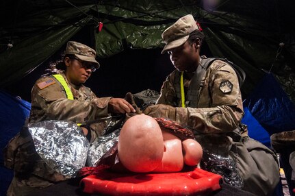 Pvt. Ladhezia Elmore and Pvt. Anissa Alcantar, both chemical specialists with the 44th Chemical Company out of Fort Bliss, Texas, evaluate a simulated casualty before transferring them to military medics Aug. 30 at Retama Park in San Antonio. The exercise involved military and San Antonio civilian first responders of the chemical, biological, radiological, nuclear response enterprise where they trained together as part of an interagency response exercise Aug. 22-29 in San Antonio to improve readiness and preparedness in the event of such a disaster.