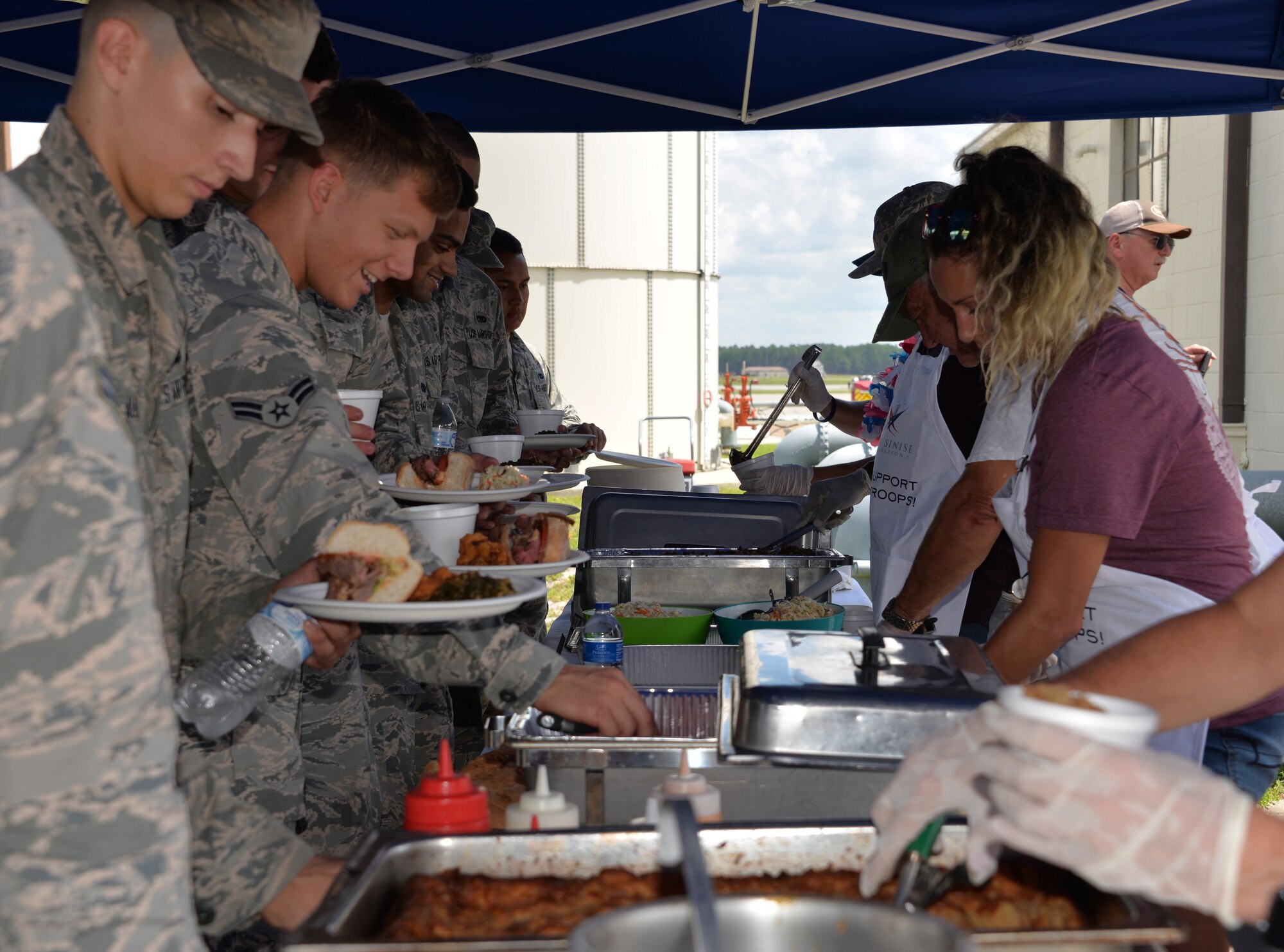 U.S. Air Force Airmen receive free food during a lunch benefit held by the Gary Sinise Foundation at Tyndall Air Force Base, Florida, Aug 27, 2018. The foundation’s Serving Heroes program has supplied more than 98,400 meals for service members in an effort to give back to active-duty men and women. This specific event served 300 meals to ranks E-4 and below, and the last 45 minutes were open to all active-duty personnel. Information about events like this can be found by contacting the local base Force Support Squadron. (Courtesy photo)