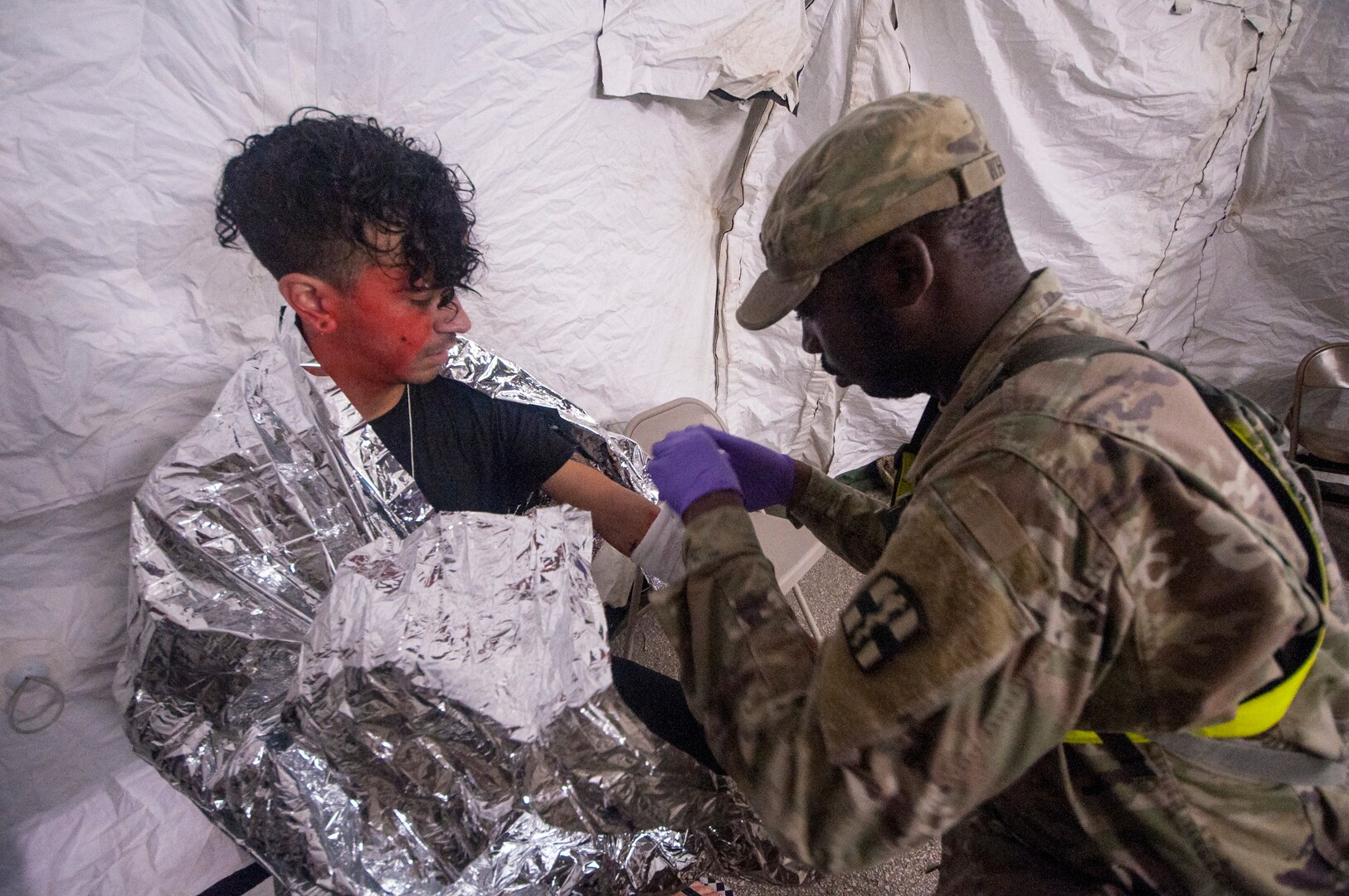 Spc. Corey White, a combat medic with 581st Medical Brigade out of Fort Hood, assesses a role-player’s notional injuries during a field training exercise Aug. 30 at Retama Park in San Antonio. The exercise involved military and San Antonio civilian first responders of the chemical, biological, radiological, nuclear response enterprise where they trained together as part of an interagency response exercise Aug. 22-29 in San Antonio to improve readiness and preparedness in the event of such a disaster.