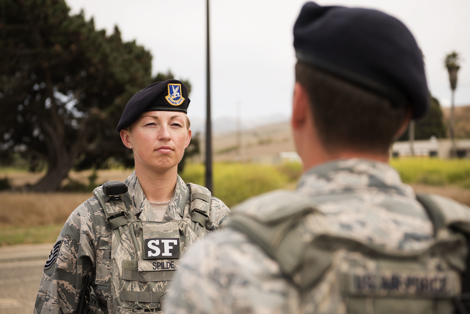 Tech. Sgt. April Spilde, flight chief for the 30th Security Forces Squadron, inspects her Airmen as they offer her a post briefing August 2, 2018, on Vandenberg Air Force Base. Airmen report their post when leadership visits and it helps in maintaining discipline and military bearing. (U.S. Air Force photo by Airman 1st Class Hanah Abercrombie)