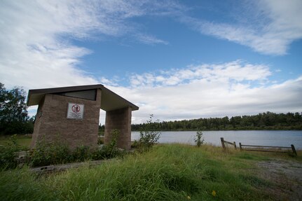A sign announcing the removal of waste bins hangs on a vault toilet at Green Lake Chalet at Joint Base Elmendorf-Richardson, Alaska, Aug. 30, 2018. The 673d Force Support Squadron is adopting the National Parks Service waste policy – pack-in, pack-out – at four base lakes this year.