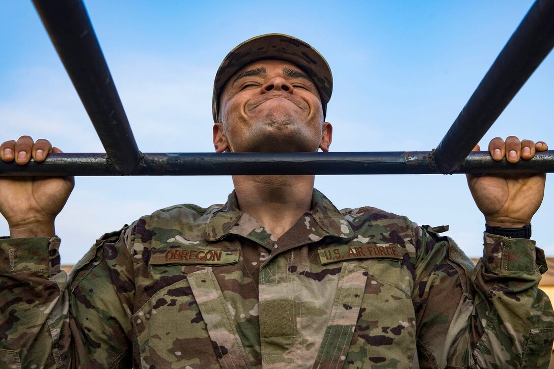 An airman performs a pullup.