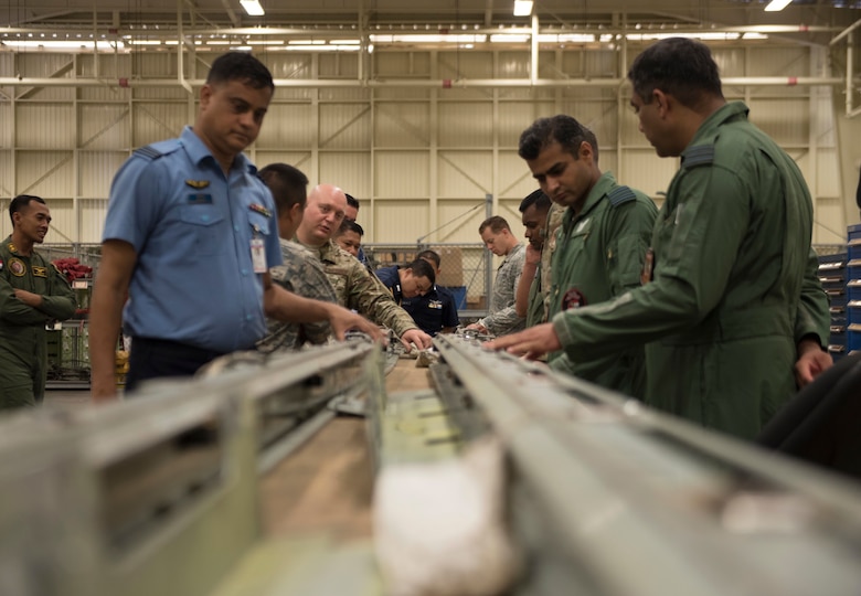 Foreign air force members view corrosion prevention and repair techniques during the 2018 Fighter Logistics and Safety Symposium Aug. 29, 2018, at Kadena Air Base, Japan. Air force officers from Malaysia, Japan, Bangladesh, Sri Lanka, Thailand, Australia, Indonesia and India attended the symposium to boost fighter interoperability within the Pacific region.