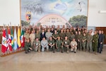 Service members from 10 countries pose for a photo