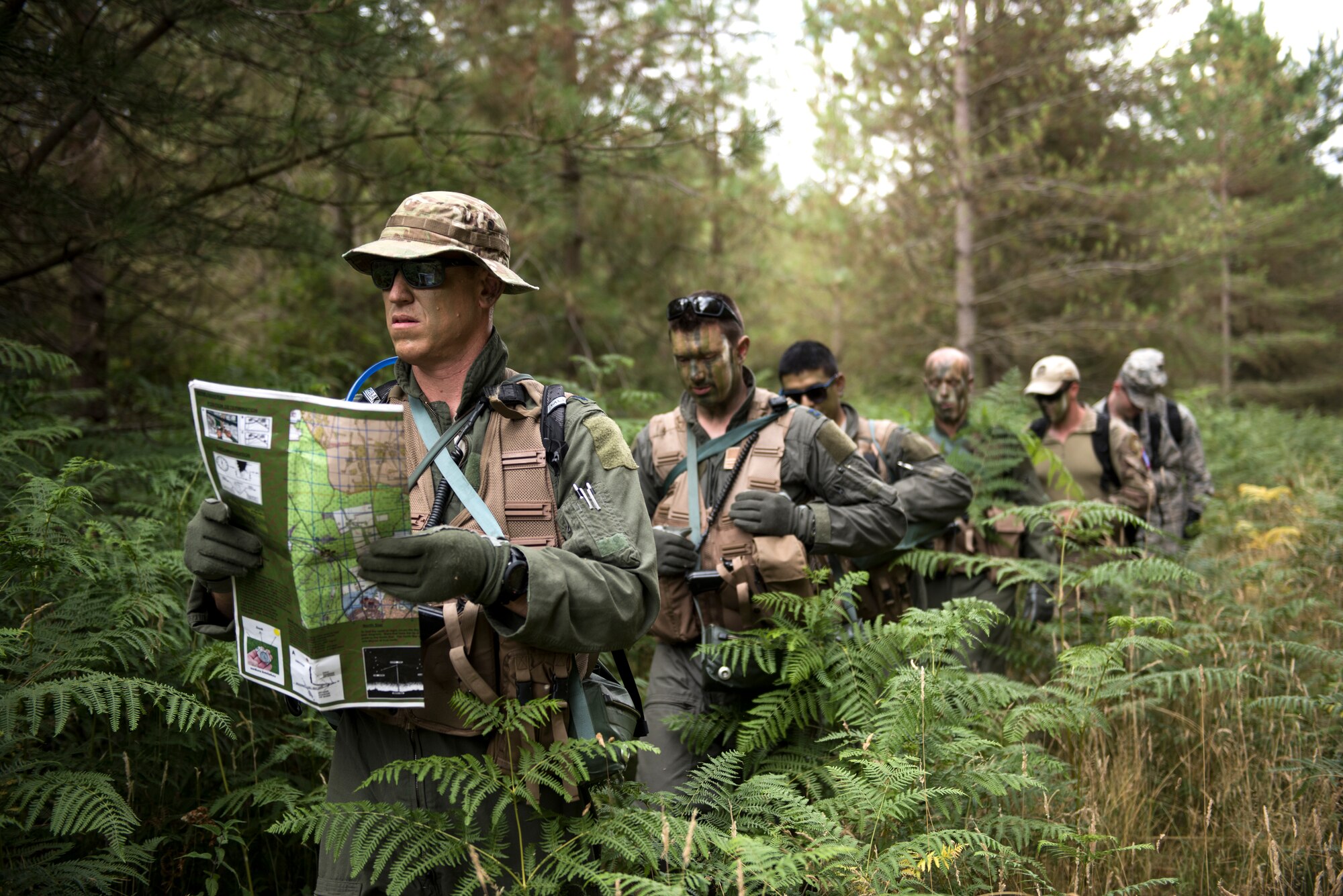 Aircrew from the 48th Operations Group conduct land navigation during Combat Survival Training at the Stanford Training Area in Norfolk, England, July 25, 2018. SERE specialists train Airmen on an array of skills needed for survival. The program contains a dozen training courses to include; Local Area Survival, Conduct After Capture, Combat Survival Training, Water Survival Training and Emergency Parachute Training. (U.S. Air Force photo/Senior Airman Malcolm Mayfield)