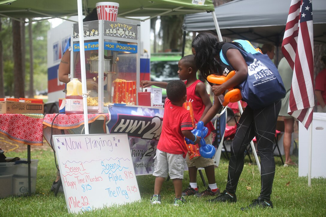 Attendants visit a booth during a military appreciation day on Laurel Bay, Aug. 25. The booth was sponsored by Highway 21 Drive-In movie theater.