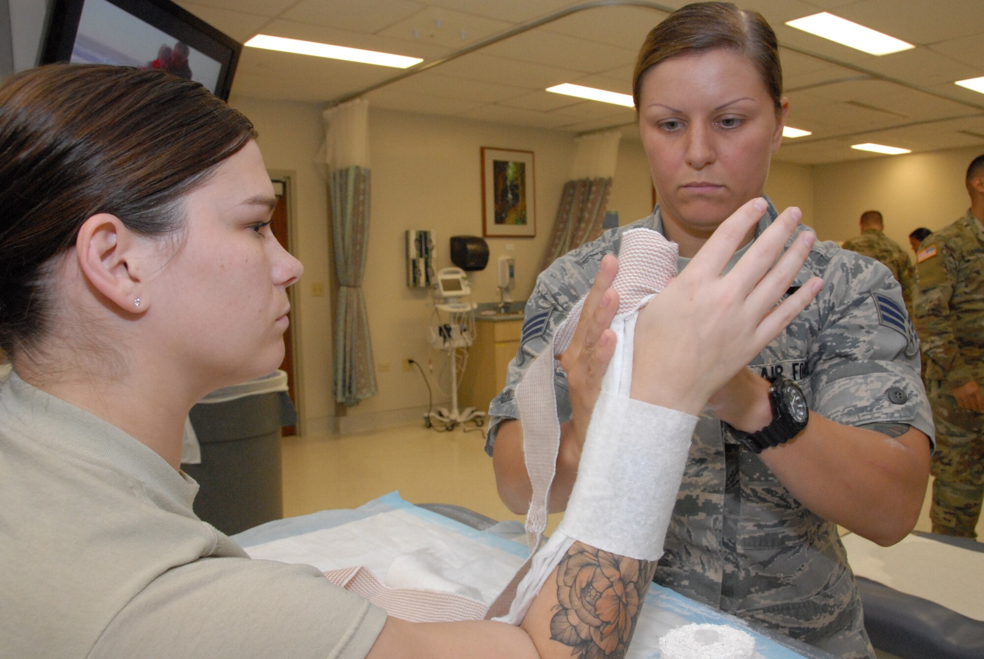 Oregon Air National Guard Senior Airman Margo Testa (right) practices applying a splint on her fellow medic, Senior Airman Taryn Lommasson, during annual training at Tripler Army Medical Center, in Honolulu, Hawaii, Aug. 28, 2018. Testa and Lommasson were part of a team from the 142nd Medical Group which took part in Medical Facilities Annual Training, Aug. 18-31, 2018, Medics from the unit were able to assist in a real-world support mission when Hurricane Lane threatened to strike the Hawaiian Islands the week of Aug. 20, 2018. (U.S. Air National Guard Photo by Master Sgt. Nick Choy)