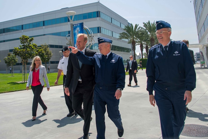 Deputy Defense Secretary Patrick Shanahan and a group of people walk during a tour.