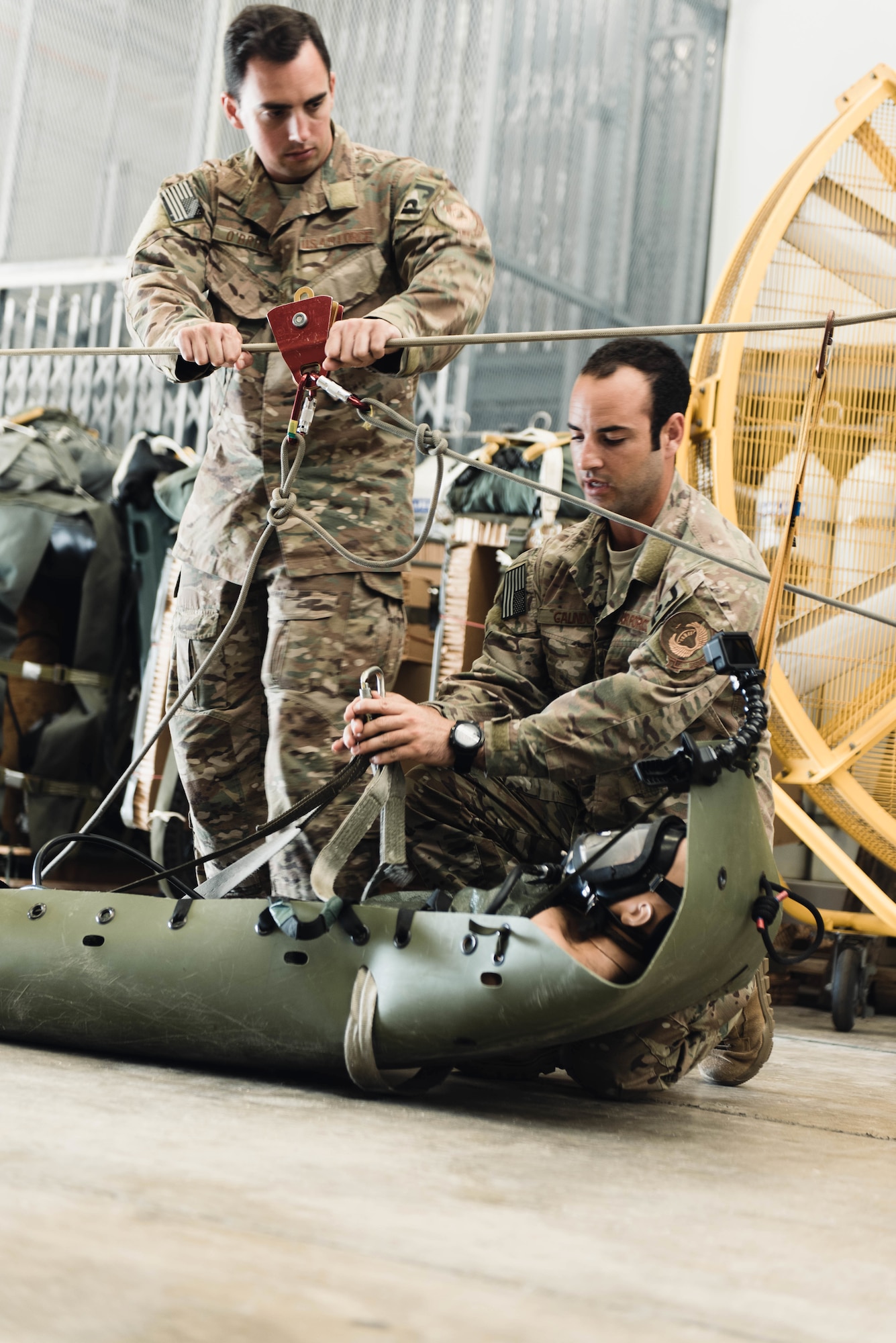 Tech. Sgt. Kenneth O’Brien and Staff Sgt. Michael Galindo, 320th Special Tactics Squadron pararescuemen, lower and detach a training dummy from a rope system, Aug. 20, 2018, at Kadena Air Base, Japan. Dozens of U.S. military personnel, including pararescue Airmen based in Okinawa, were part of a multinational effort that saved 12 young soccer players and their coach from a flooded cave in Thailand. (U.S. Air Force photo by Senior Airman Omari Bernard)
