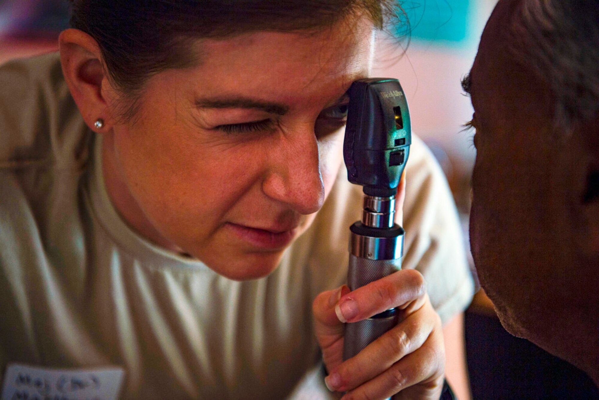Maj. Lauren Matthews, 18th Medical Group optometrist, Kadena Air Base, Japan, examines a patient’s eye during Pacific Angel18-4 in Vavuniya, Sri Lanka, Aug. 17, 2018. PAC ANGEL 18 is a joint and combined engagement that enhances participating nations’ humanitarian assistance and disaster relief capabilities while providing beneficial services to people in need throughout South and Southeast Asia and includes general health, dental, optometry, pediatrics and engineering programs as well as various subject-matter expert exchanges. (U.S. Air Force photo by Tech. Sgt. Heather Redman)