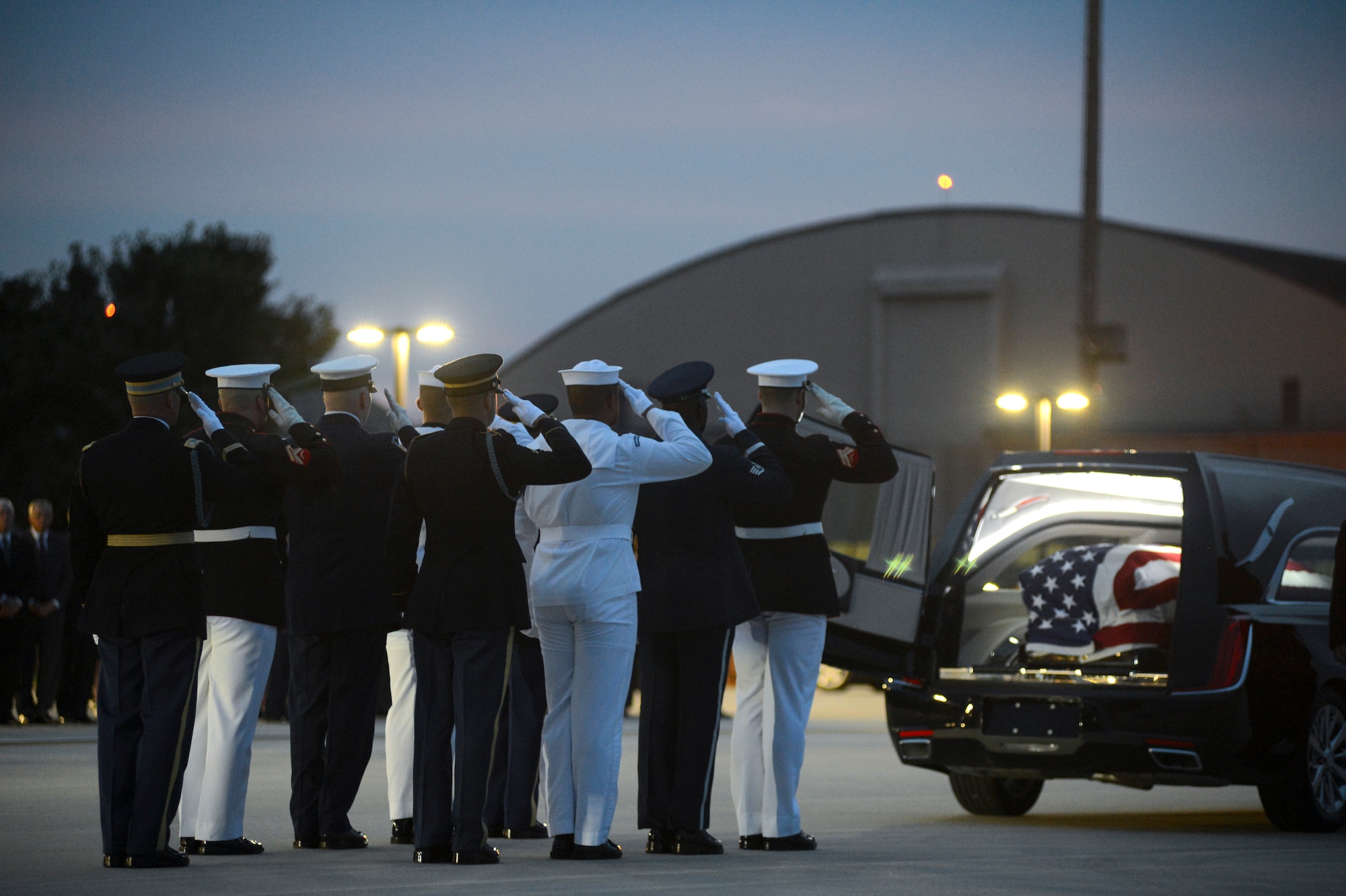 Members of the Joint Service Arrival Team render a final salute after transferring the casket of Sen. John McCain from an 89th Airlift Wing C-32 aircraft to a hearse at Joint Base Andrews, Md., Aug. 30, 2018. (U.S. Air Force photo by Staff Sgt. Kenny Holston)