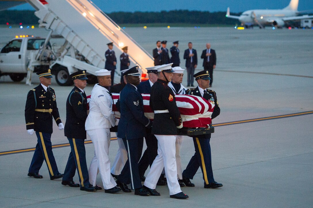 Members of the Joint Service Arrival Team carry the casket of Sen. John McCain at Joint Base Andrews, Md., Aug. 30, 2018. DoD personnel are honoring the former senator, and retired Navy Captain, by providing ceremonial support to his congressional funeral events. (U.S. Air Force photo by Master Sgt. Michael B. Keller)
