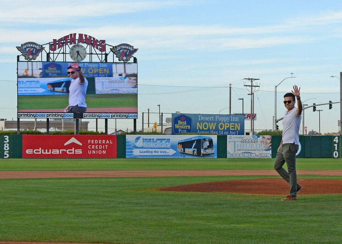 Airman 1st Class Ikraam Khondaker, 412th Communications Squadron, walks in front of the mount before throwing out a ceremonial first pitch before the Lancaster JetHawks game Aug. 30. (U.S. Air Force photo by Kenji Thuloweit)