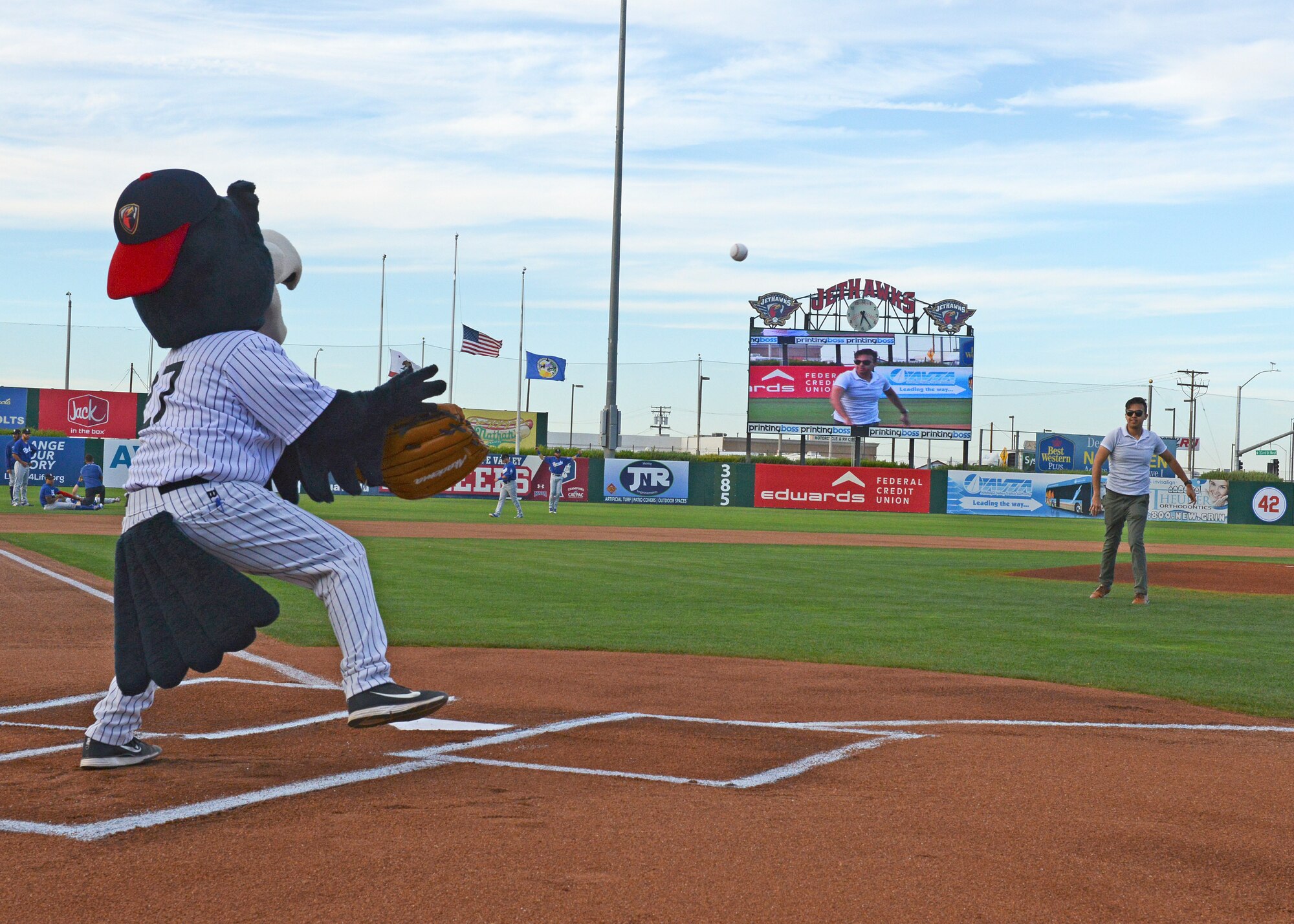 Airman 1st Class Ikraam Khondaker, 412th Communications Squadron, walks in front of the mount before throwing out a ceremonial first pitch before the Lancaster JetHawks game Aug. 30. (U.S. Air Force photo by Kenji Thuloweit)