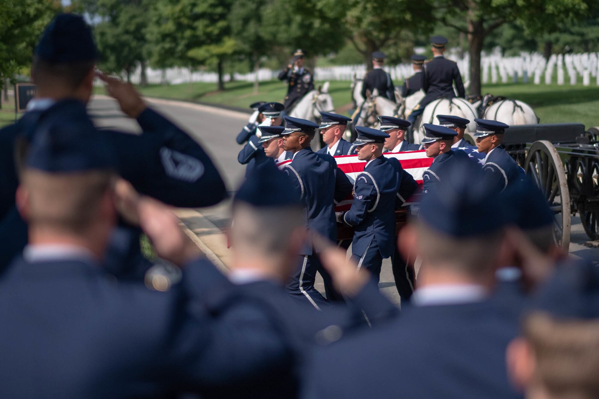 Airmen with the 732nd Airlift Squadron with the 514th Air Mobility Wing, render a salute to the casket of Floyd Carter Sr., who was laid to rest at Arlington National Cemetery, Va., Aug. 22, 2018.