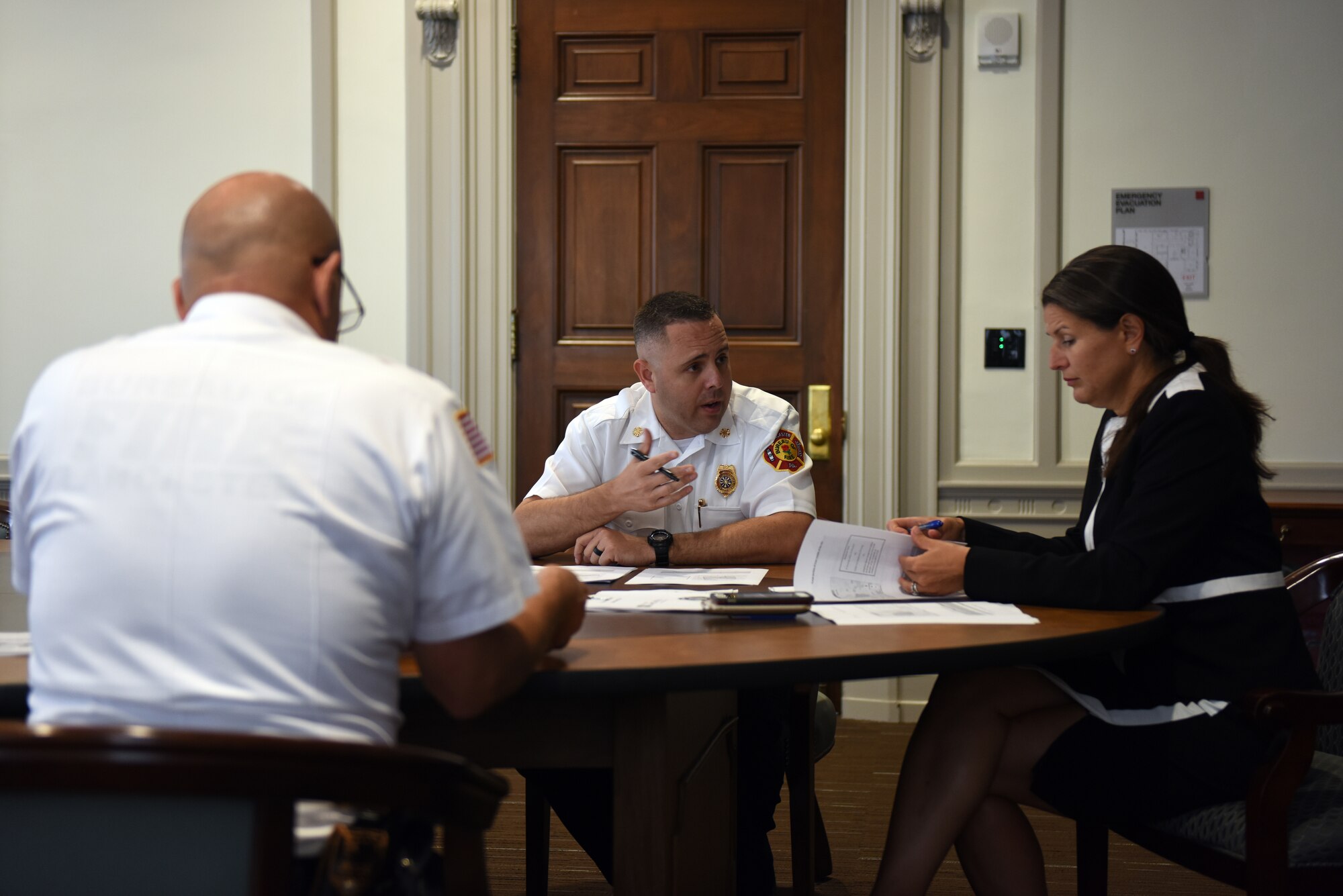Scott Little, center, fire chief of Lancaster’s Bureau of Fire, and David Amico, deputy chief of Lancaster’s Bureau of Fire, meet with Lancaster’s Mayor Danene Sorace to discuss the possible addition and remodeling of firehouses as well as improving their fire rescue service delivery Aug. 21, 2018, Lancaster, Pennsylvania. The meeting resulted in Sorace approving a budget of up to 10 million dollars for this specific project. (U.S. Air National Guard photo by Senior Airman Julia Sorber/Released)